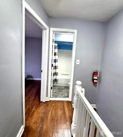 a view of a hallway view with wooden floor and staircase