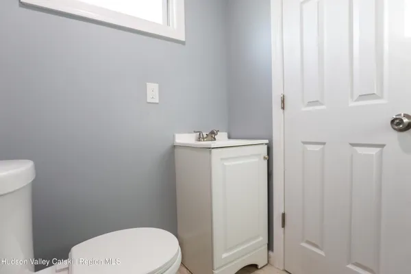 a bathroom with a toilet a sink and a window