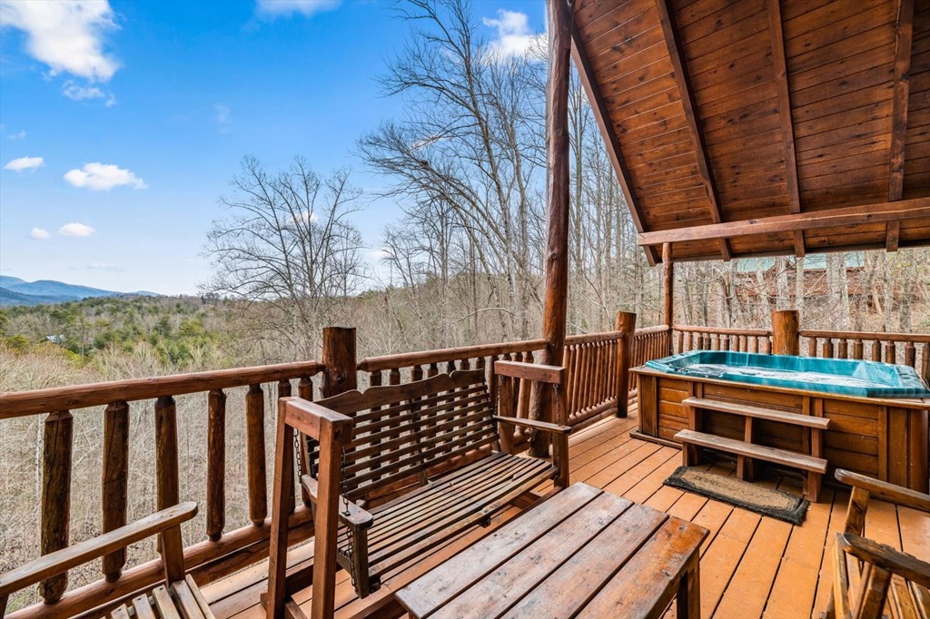 4130 Evans Chapel Road Sevierville, TN 37876 - Photo 28 of 33 a balcony with wooden floor table and chairs
