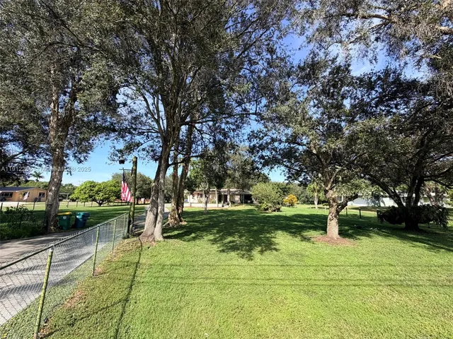 a view of a park with large trees