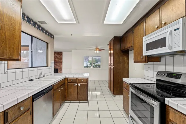 a kitchen with a sink stove and cabinets
