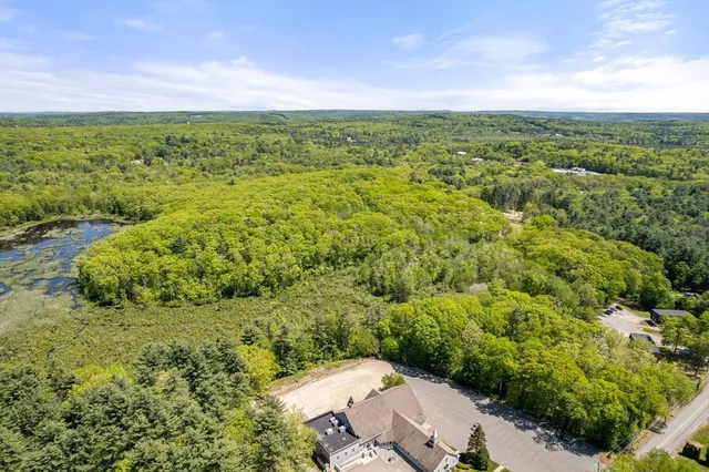 a view of a green field with lots of bushes