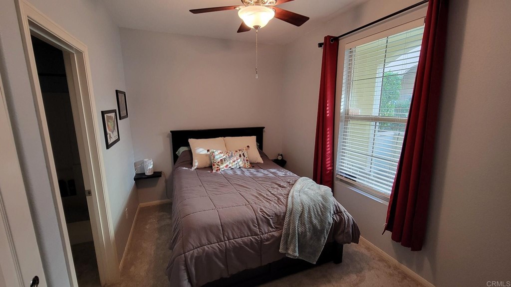 236 Marquette Avenue San Marcos, CA 92078 - Photo 3 of 7 a bedroom with a bed and a chandelier