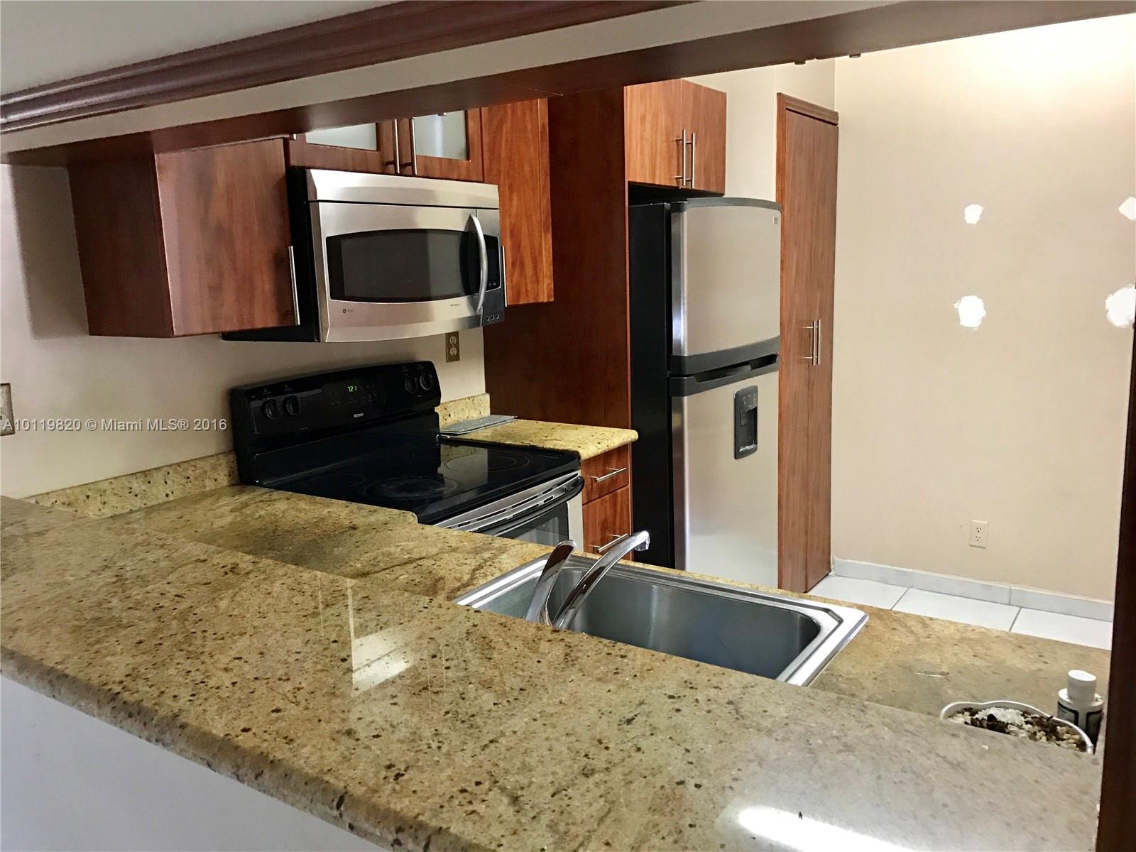9079 Southwest 138th Place, Unit 9079 Miami, FL 33186 - Photo 1 of 34 a kitchen with stainless steel appliances granite countertop a refrigerator and a stove