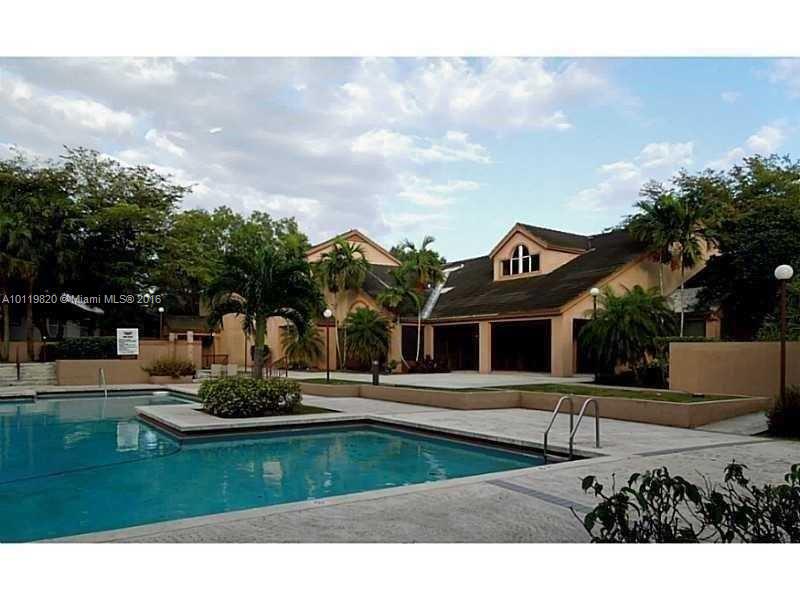 9079 Southwest 138th Place, Unit 9079 Miami, FL 33186 - Photo 12 of 34 a front view of a house with a yard