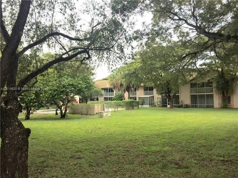 9079 Southwest 138th Place, Unit 9079 Miami, FL 33186 - Photo 15 of 34 a view of a house with a big yard and large trees