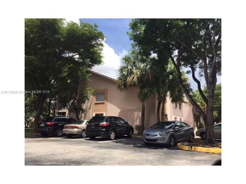 9079 Southwest 138th Place, Unit 9079 Miami, FL 33186 - Photo 16 of 34 a view of a car parked in front of a house