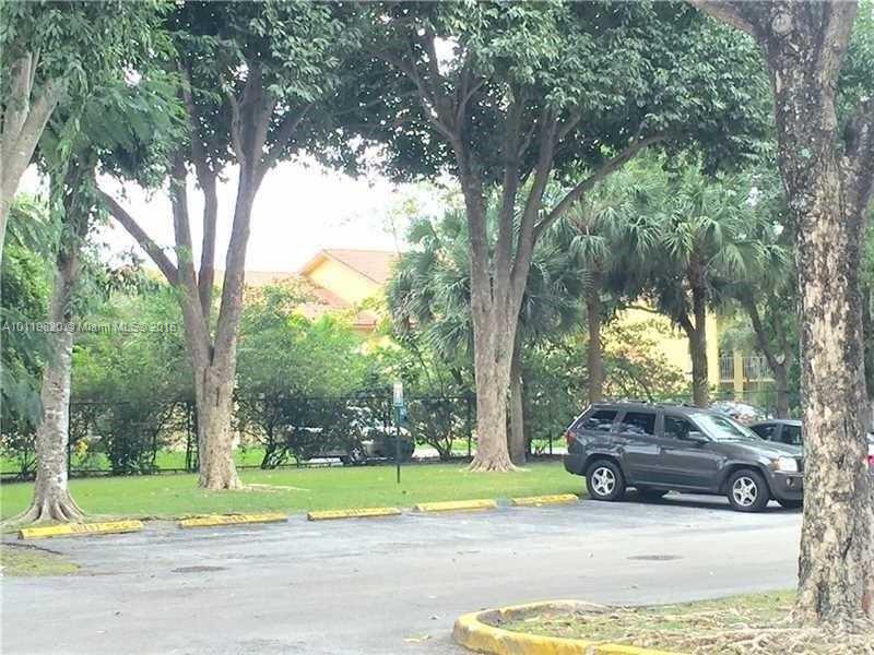 9079 Southwest 138th Place, Unit 9079 Miami, FL 33186 - Photo 19 of 34 a car parked on the side of the road