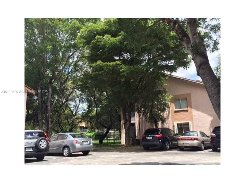 9079 Southwest 138th Place, Unit 9079 Miami, FL 33186 - Photo 22 of 34 a view of car parked on the side of a street