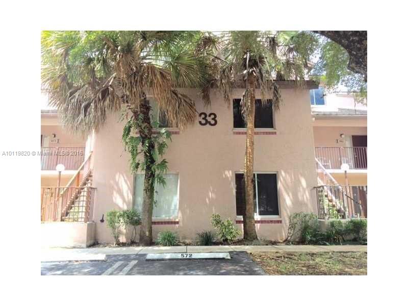9079 Southwest 138th Place, Unit 9079 Miami, FL 33186 - Photo 23 of 34 a front view of a house with a yard