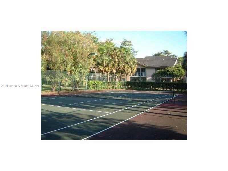9079 Southwest 138th Place, Unit 9079 Miami, FL 33186 - Photo 26 of 34 a view of a tennis court