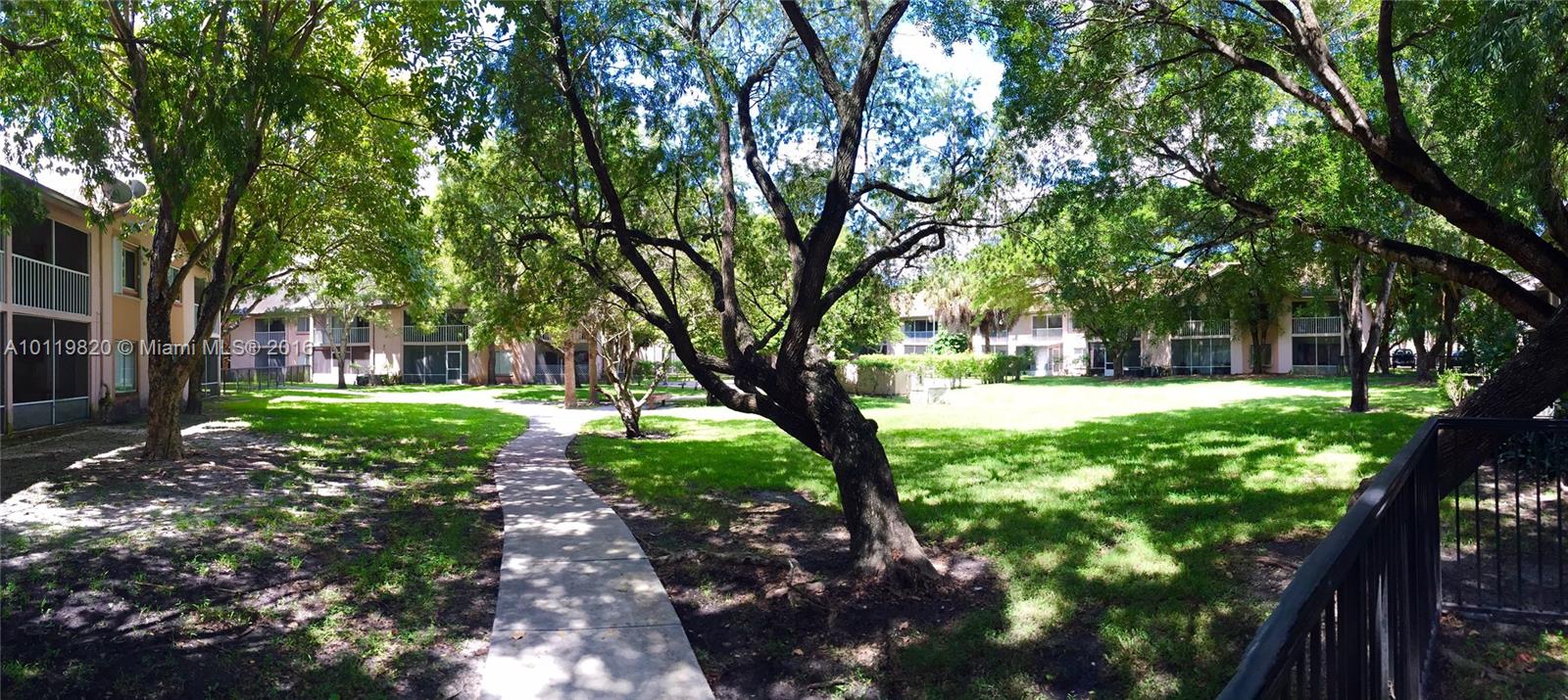 9079 Southwest 138th Place, Unit 9079 Miami, FL 33186 - Photo 27 of 34 a view of a yard with plants and trees