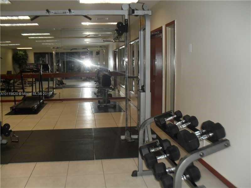 9079 Southwest 138th Place, Unit 9079 Miami, FL 33186 - Photo 30 of 34 a room with gym equipment