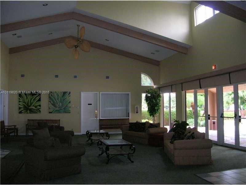 9079 Southwest 138th Place, Unit 9079 Miami, FL 33186 - Photo 31 of 34 a living room with furniture and a large window