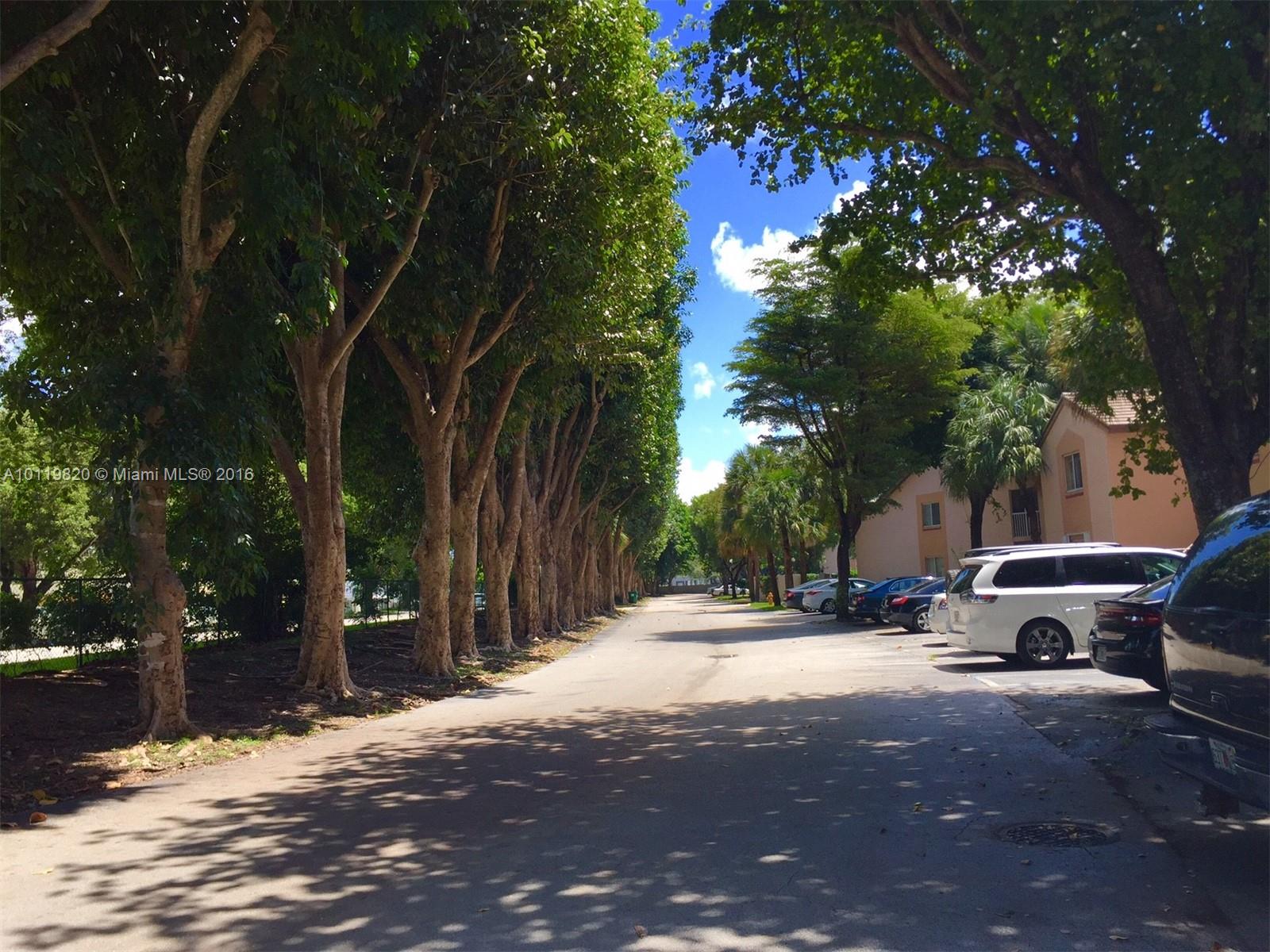 9079 Southwest 138th Place, Unit 9079 Miami, FL 33186 - Photo 33 of 34 a view of street with parked cars