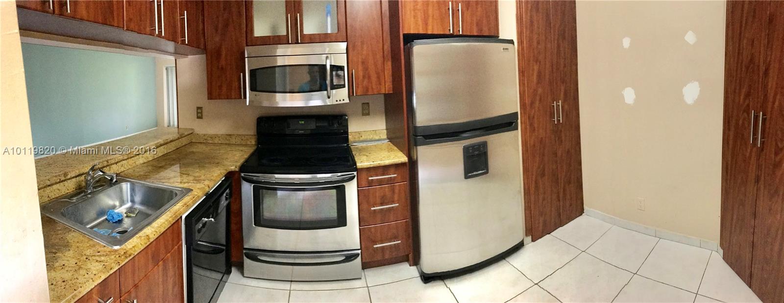 9079 Southwest 138th Place, Unit 9079 Miami, FL 33186 - Photo 34 of 34 a kitchen with a stove and a refrigerator