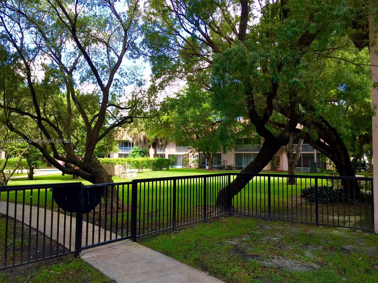9079 Southwest 138th Place, Unit 9079 Miami, FL 33186 - Photo 6 of 34 a view of a deck and a backyard