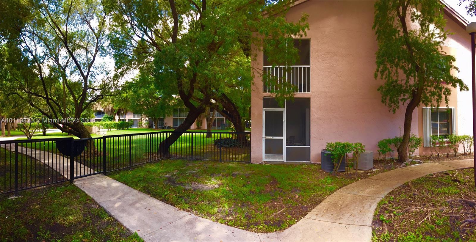 9079 Southwest 138th Place, Unit 9079 Miami, FL 33186 - Photo 7 of 34 front view of a house with a yard