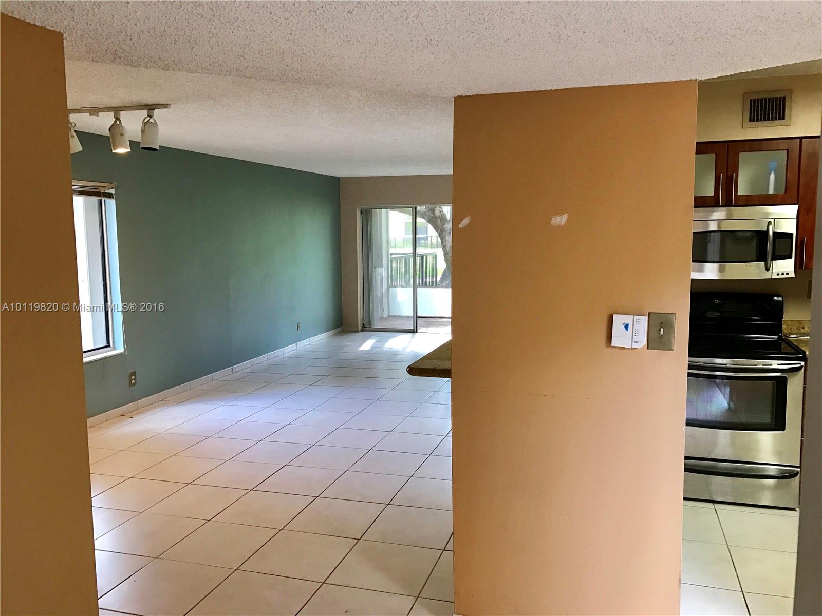 9079 Southwest 138th Place, Unit 9079 Miami, FL 33186 - Photo 8 of 34 a view of a kitchen with furniture and cabinet