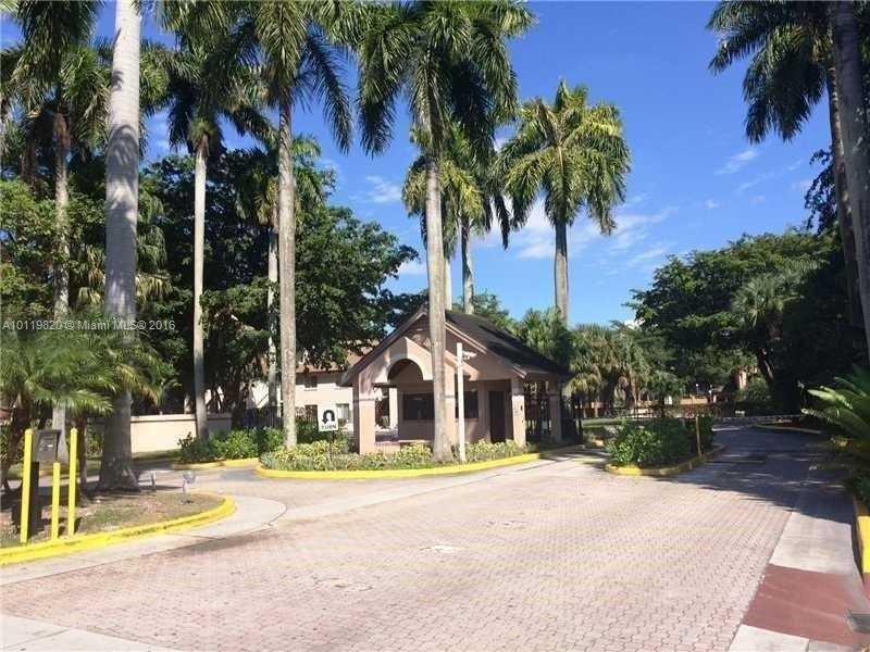 9079 Southwest 138th Place, Unit 9079 Miami, FL 33186 - Photo 9 of 34 a view of a house with palm trees