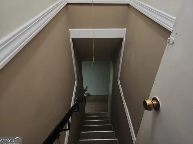 a kitchen with a refrigerator and white cabinets