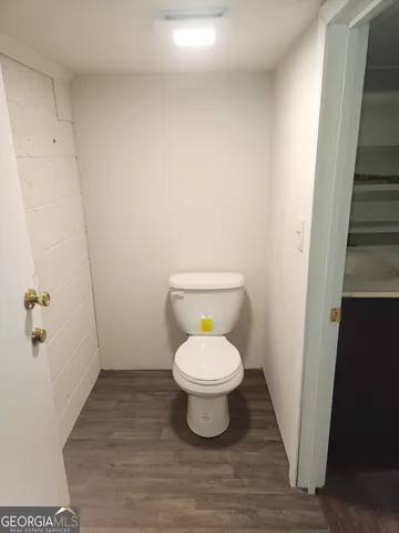a kitchen with wooden floor and a stove top oven