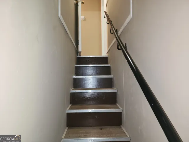 a kitchen with stainless steel appliances granite countertop a sink and wooden floors