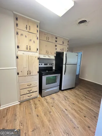 a view of kitchen with wooden floor
