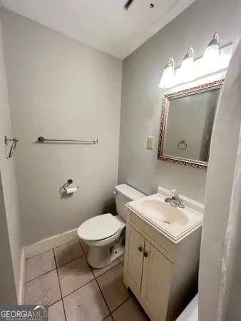 a bathroom with a sink a toilet and mirror