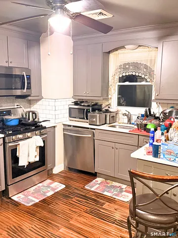 a kitchen with a sink cabinets and window