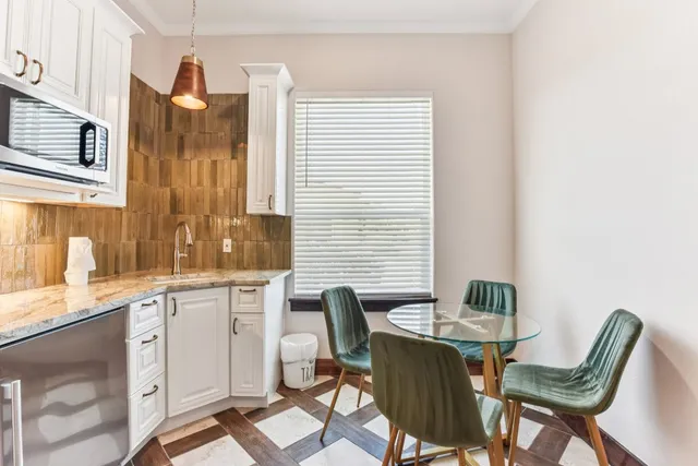 a view of a dining room with furniture and window