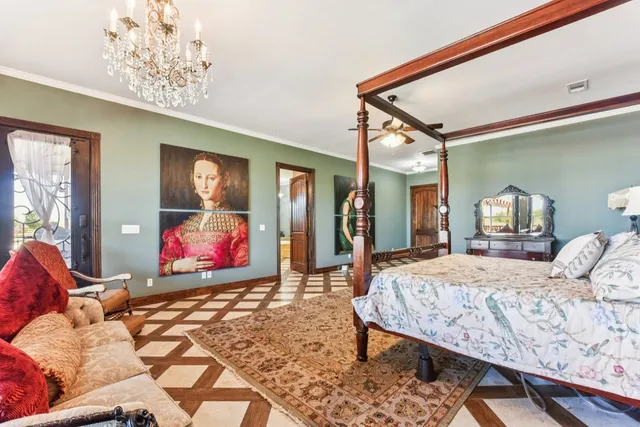 a bedroom with a bed and a chandelier