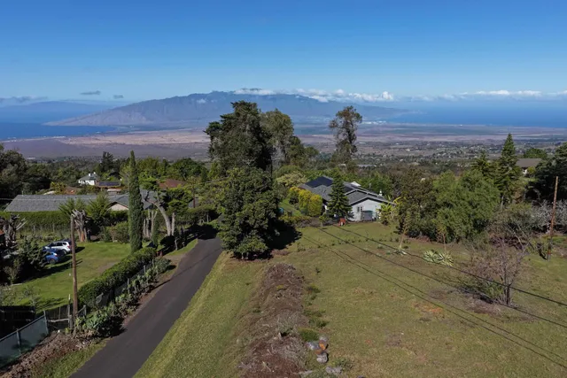 an aerial view of a houses with a yard