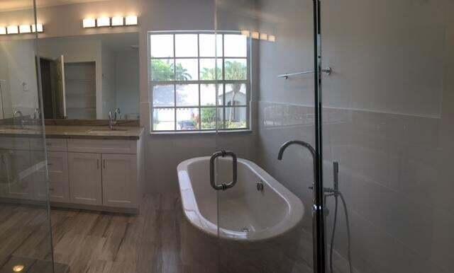 10720 Bexley Boulevard Boca Raton, FL 33428 - Photo 15 of 29 a bathroom with a sink toilet and shower