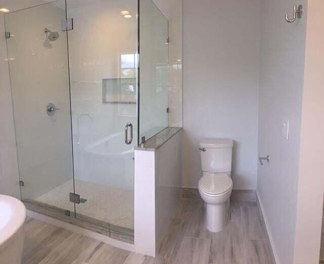 10720 Bexley Boulevard Boca Raton, FL 33428 - Photo 16 of 29 a bathroom with a toilet and a shower