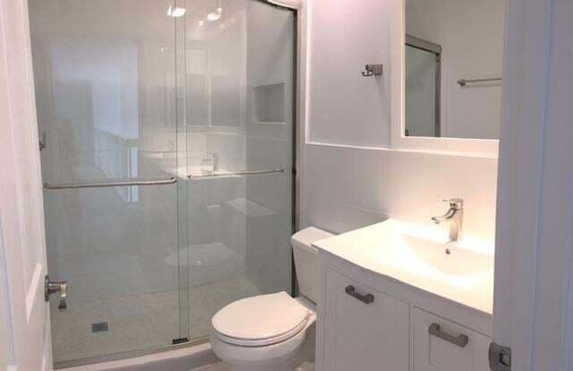 10720 Bexley Boulevard Boca Raton, FL 33428 - Photo 21 of 29 a bathroom with a sink a toilet and shower