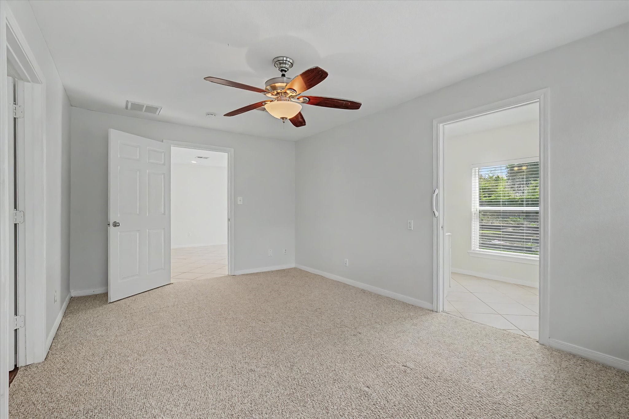 413 Farrer Street Angleton, TX 77515 - Photo 24 of 43 a view of a room with a ceiling fan and a window