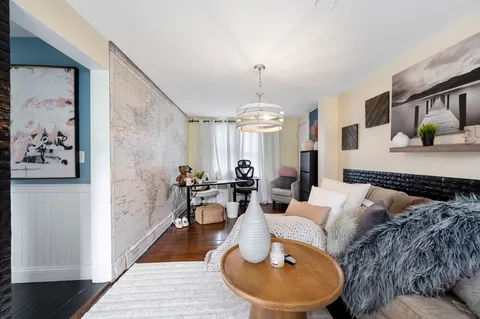 a living room with furniture and a chandelier