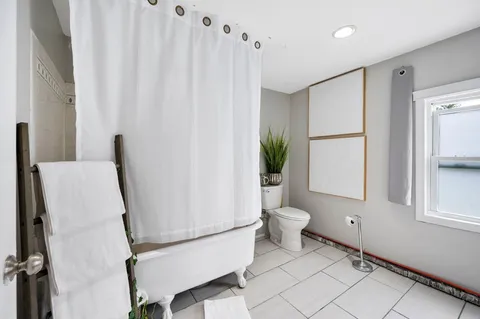 a bathroom with a toilet and a shower