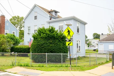 a view of a house with swimming pool next to a yard