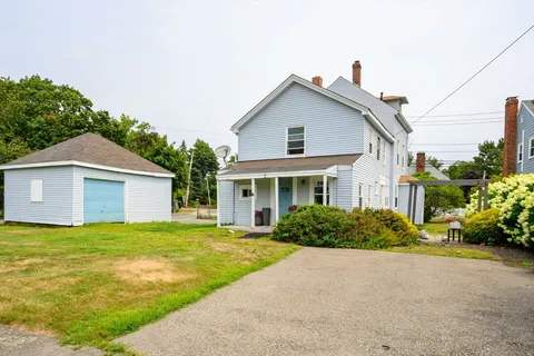 a front view of house with yard and green space