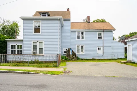 a view of a house with a yard and plants