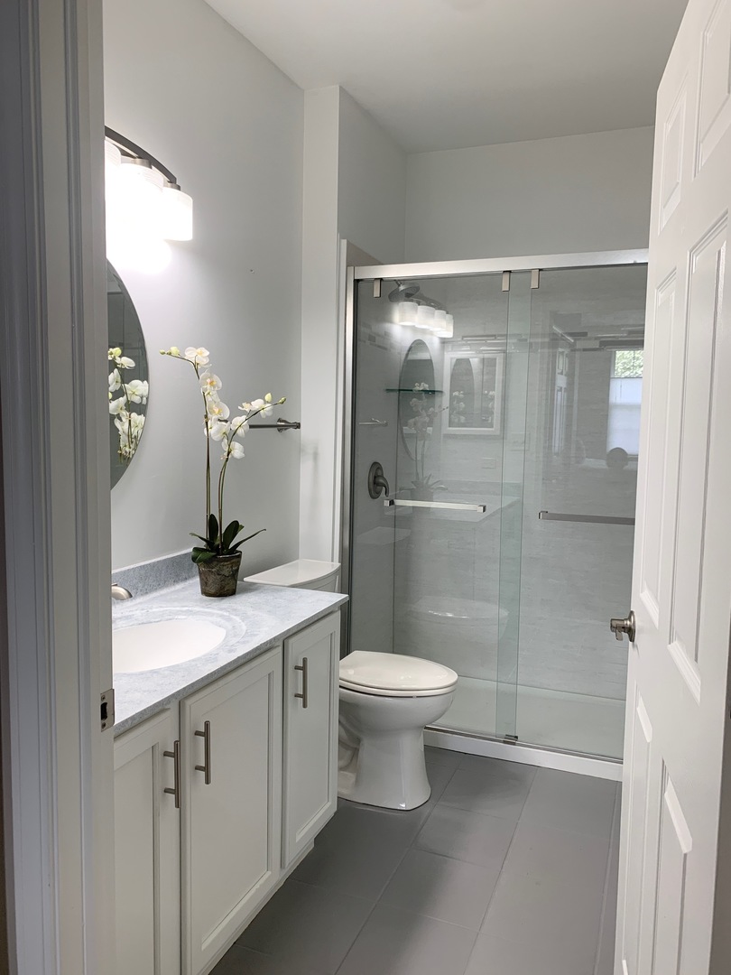 2480 Golf Ridge Circle Naperville, IL 60563 - Photo 16 of 18 a bathroom with a granite countertop sink toilet and shower
