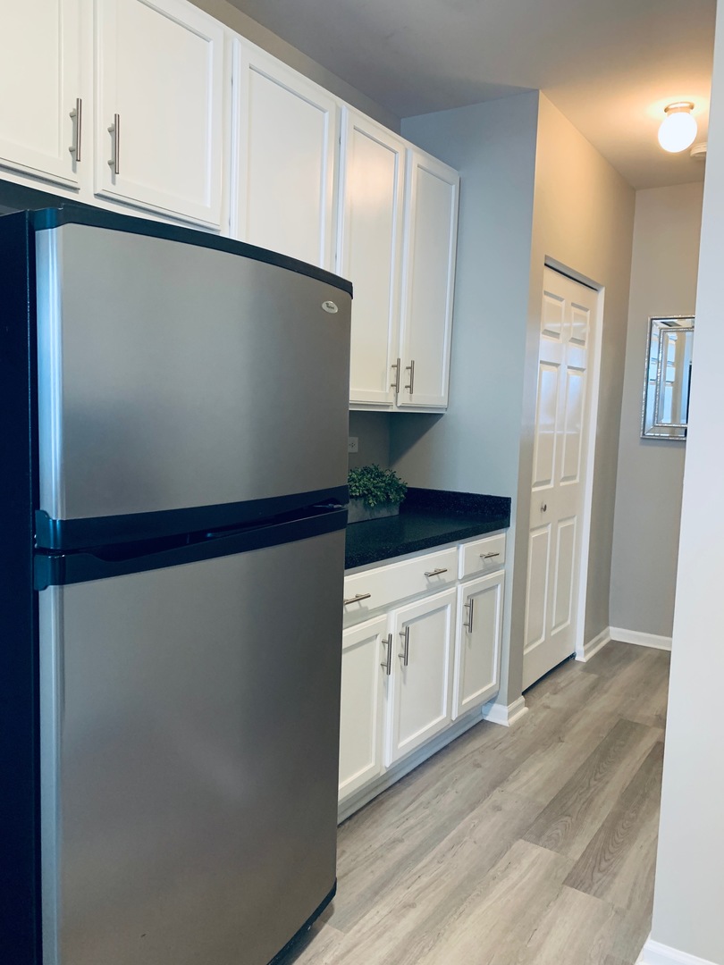 2480 Golf Ridge Circle Naperville, IL 60563 - Photo 9 of 18 a kitchen with granite countertop white cabinets and white appliances