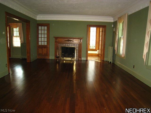 3107 Huntington Road Cleveland, OH 44120 - Photo 3 of 25 Large living room with pretty fireplace,recently refinished wood floors, corner built-in and french doors leading to the sun room.