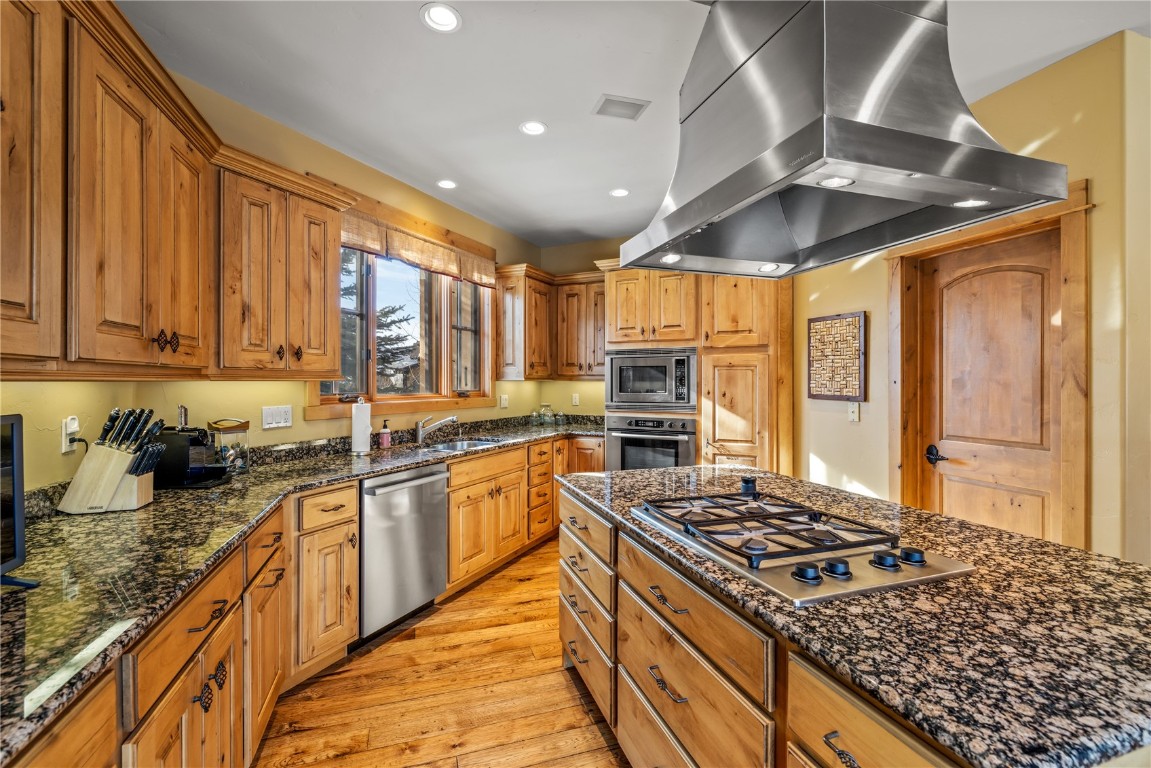 3258 Snowflake Circle, Unit 2 Steamboat Springs, CO 80487 - Photo 13 of 45 a kitchen with stainless steel appliances granite countertop a stove sink and cabinets