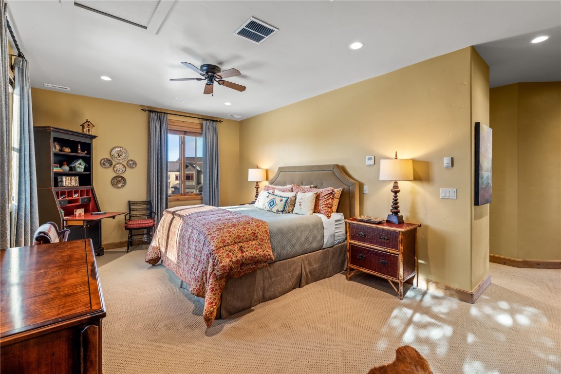 3258 Snowflake Circle, Unit 2 Steamboat Springs, CO 80487 - Photo 18 of 45 a spacious bedroom with a bed and ceiling fan