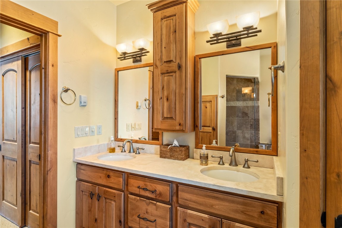 3258 Snowflake Circle, Unit 2 Steamboat Springs, CO 80487 - Photo 19 of 45 a bathroom with a double vanity sink mirror and double