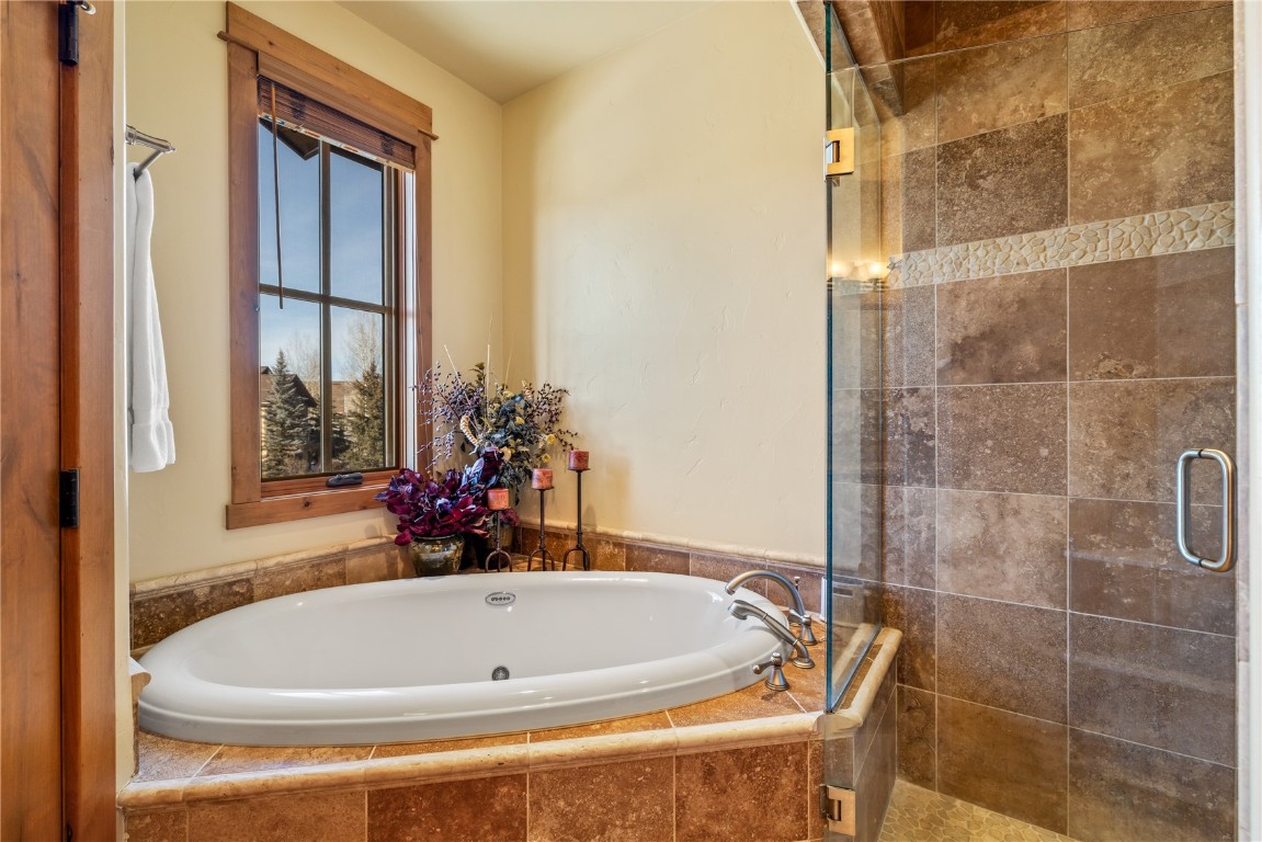 3258 Snowflake Circle, Unit 2 Steamboat Springs, CO 80487 - Photo 20 of 45 a white bath tub sitting next to a window