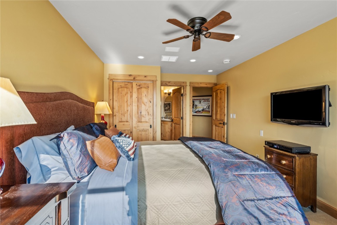 3258 Snowflake Circle, Unit 2 Steamboat Springs, CO 80487 - Photo 24 of 45 a bedroom with a bed and a flat screen tv